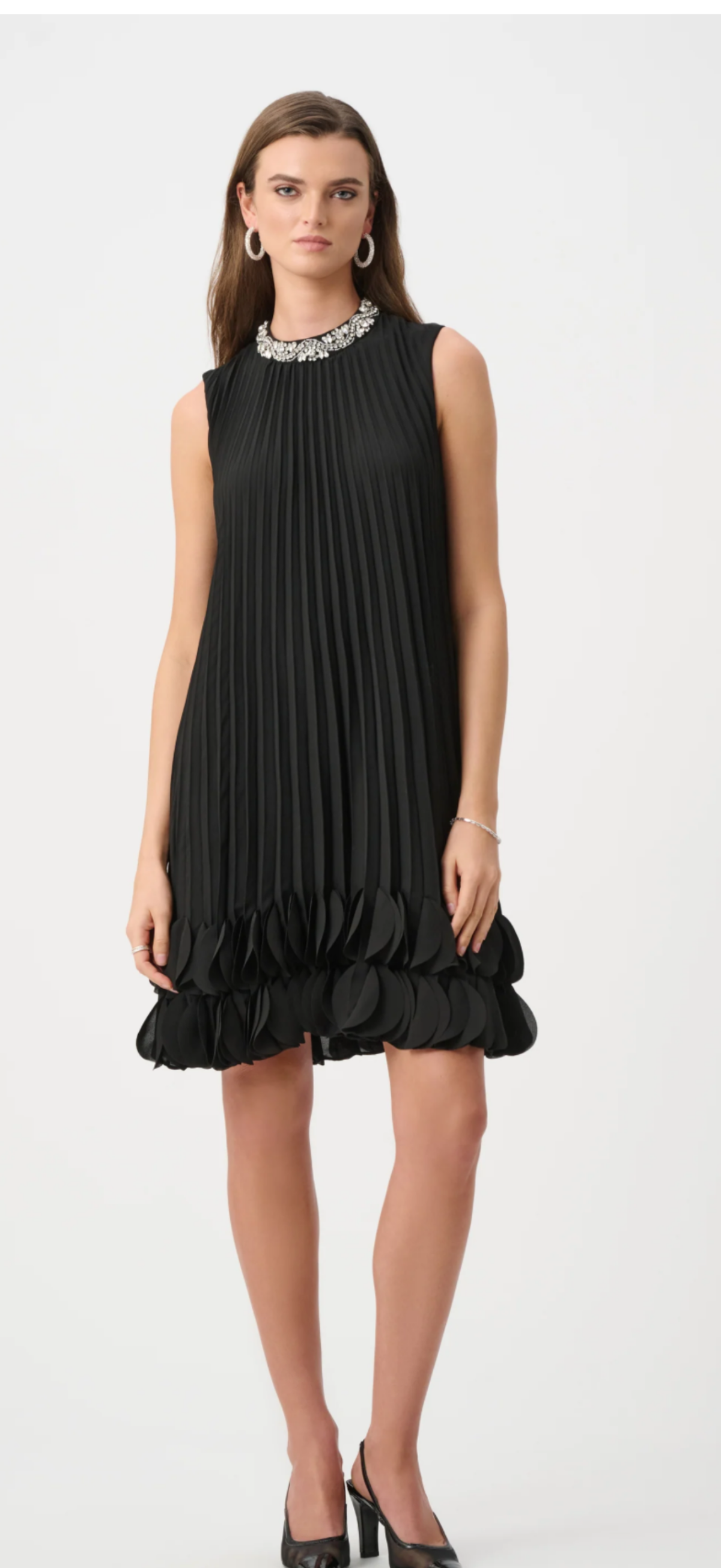 Joseph Ribkoff black pleated A line dress with rhinestone accent at neck, sleeveless, and 2 rows of ruffle at the hem